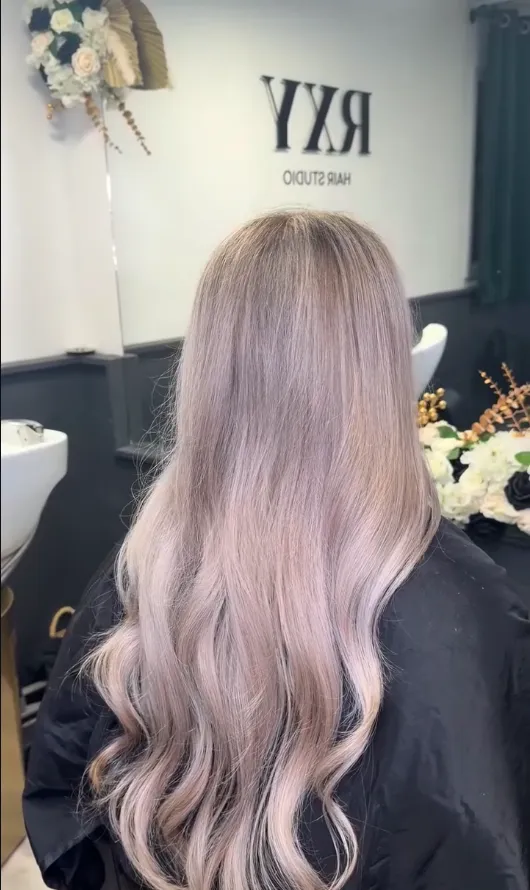Long dusty rose-toned waves, seen from behind in the studio