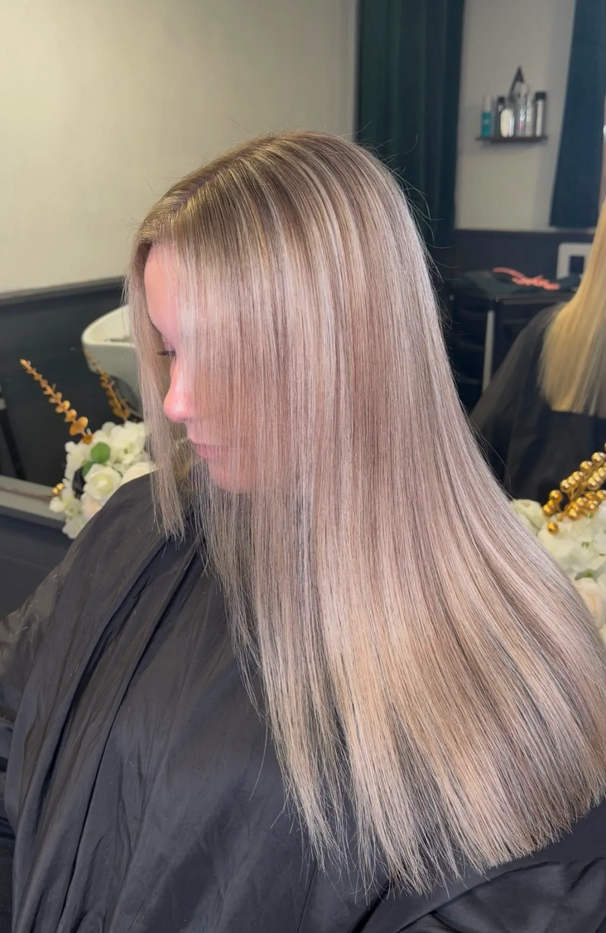Sleek, straight silver-blonde hair, profile view